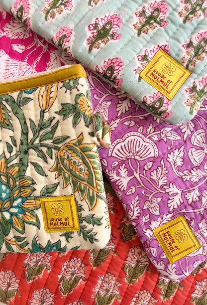 Hand Block Printed Quilted Travel Wristlet Pouch & Organizer. Fabric samples with floral patterns and 'House of Mulmul' label on a colorful background