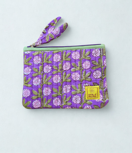 House of Mulmul - Quilted Flat Passport Pouch. Purple floral patterned pouch with a yellow label on a light gray background.