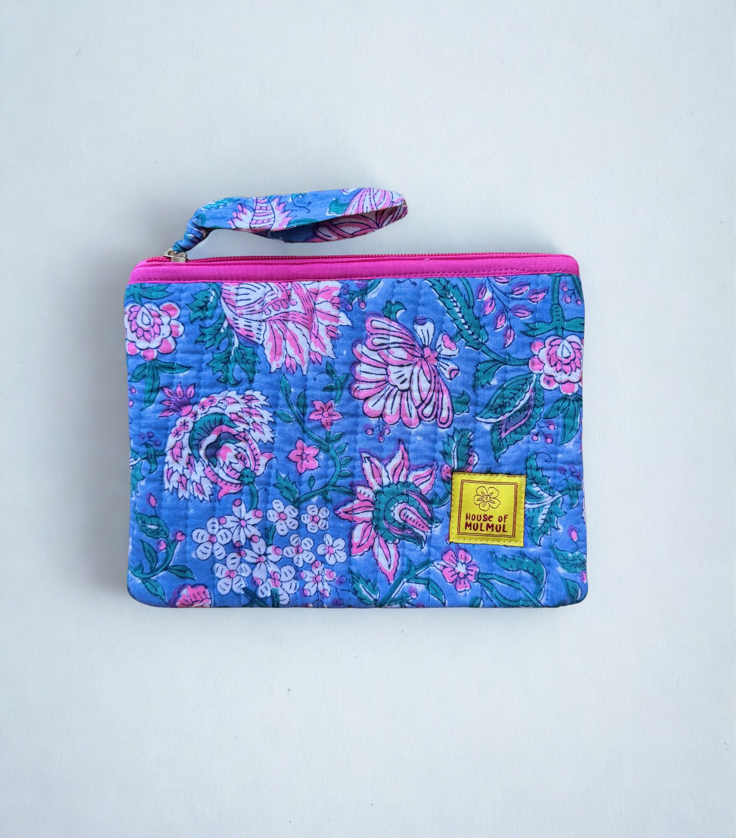 House of Mulmul - Quilted Flat Passport Pouch. Floral-patterned pouch with a visible brand label on a light gray background.