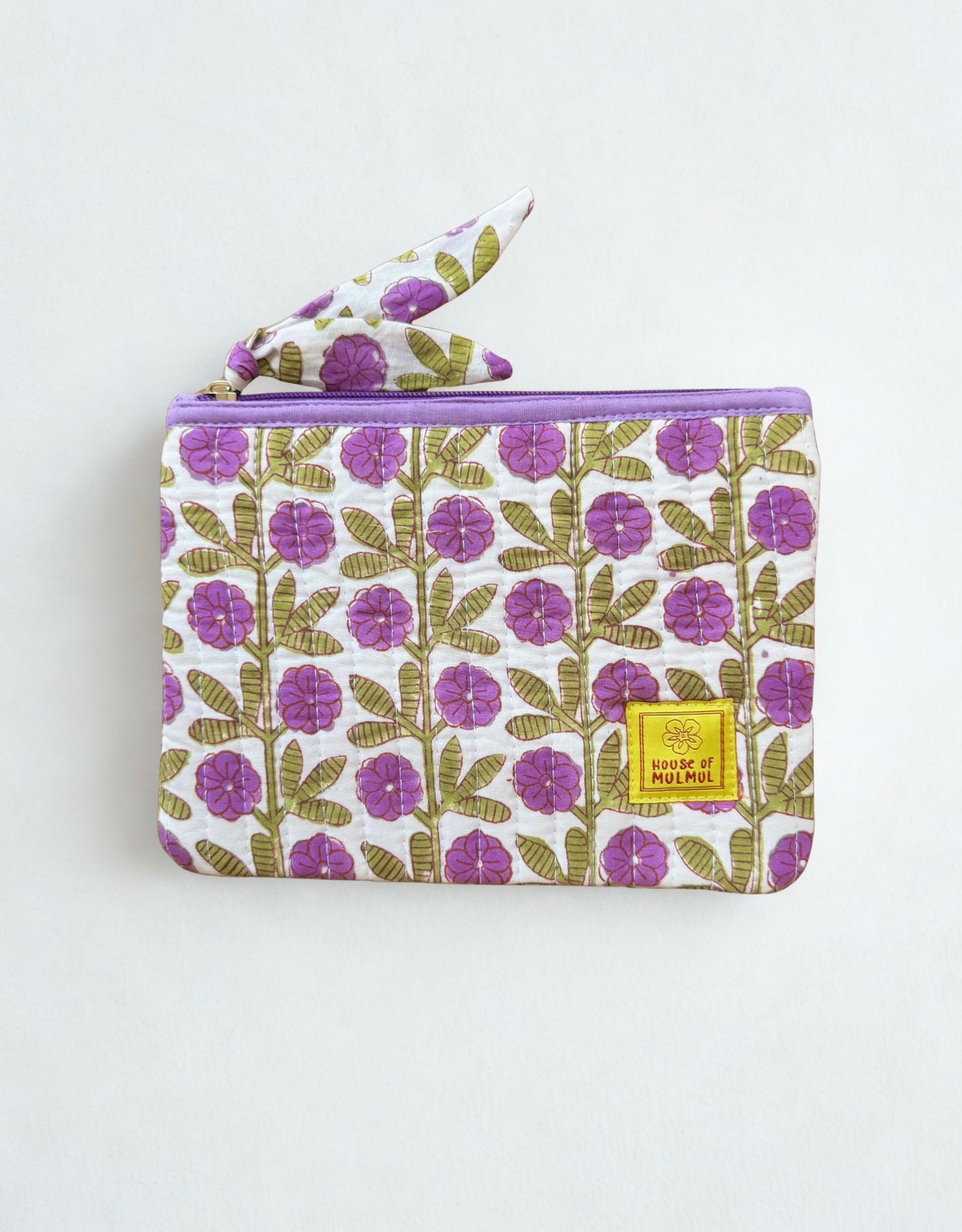 House of Mulmul - Quilted Flat Passport Pouch. Floral-patterned pouch with a yellow label on a white background