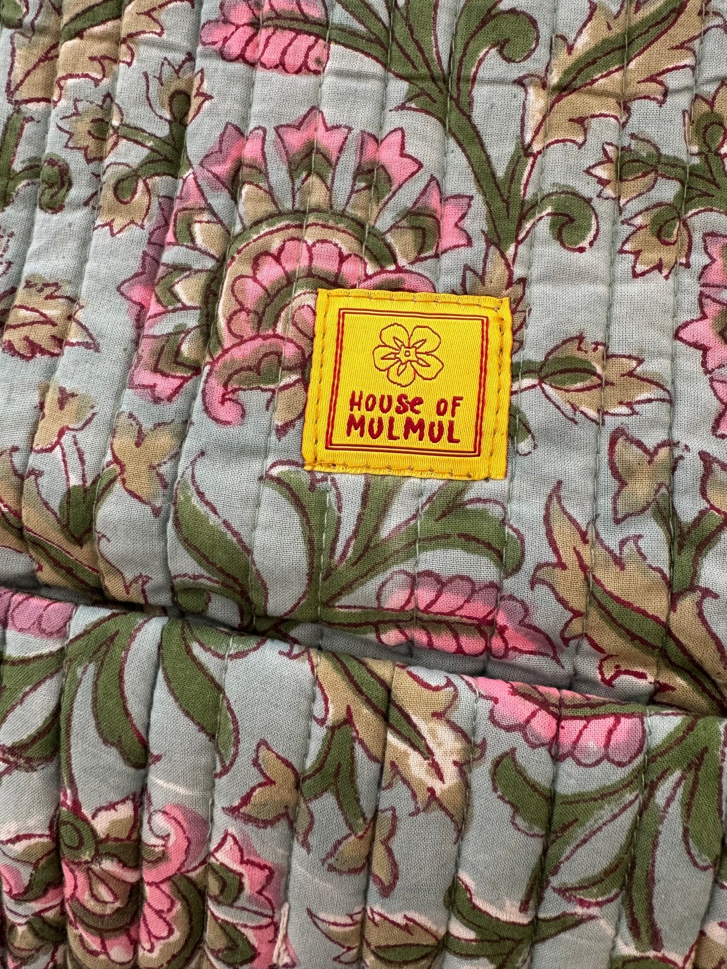 Floral patterned handblock printed fabric with a 'House of Mulmul' label.