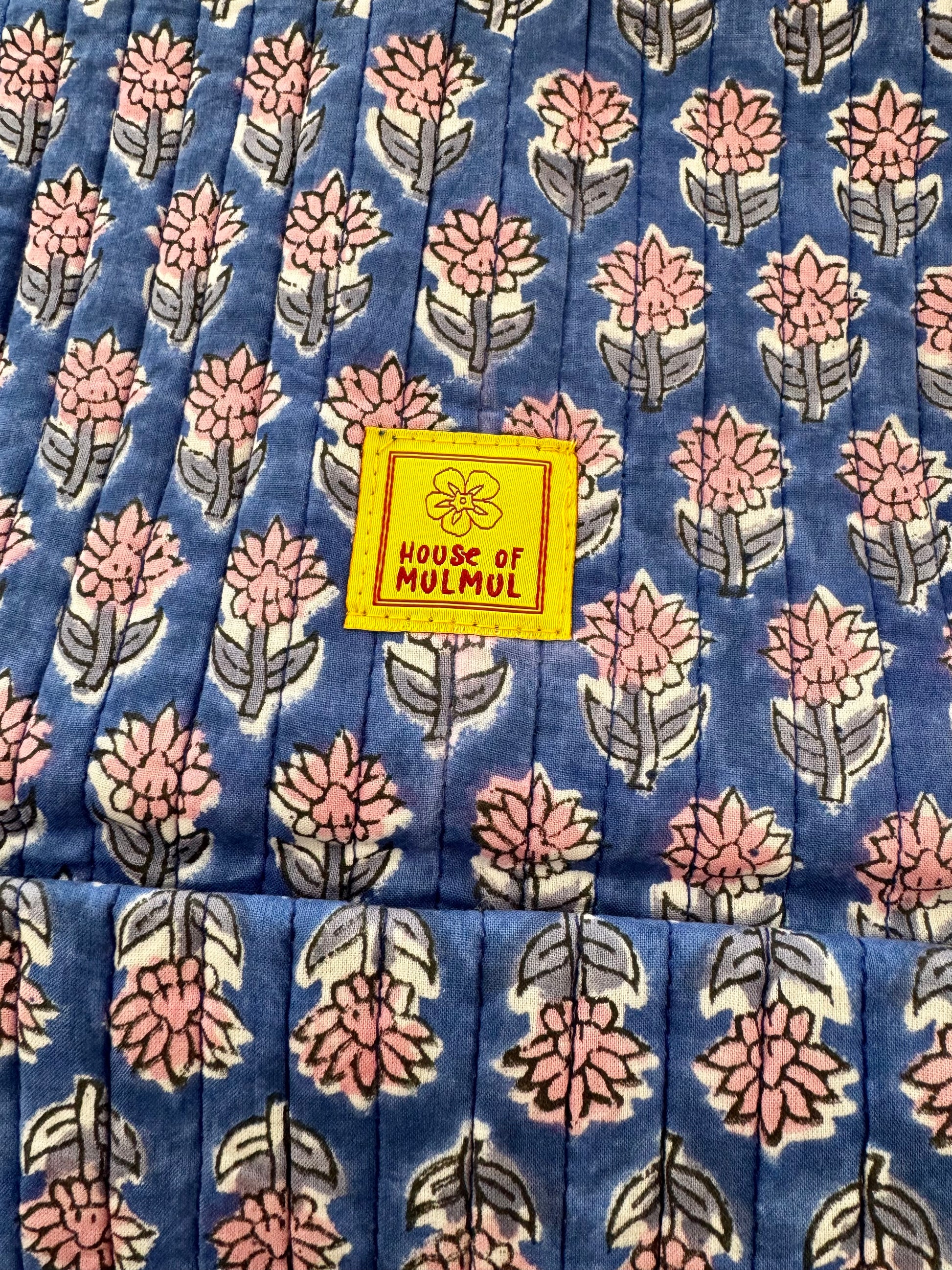 Floral patterned handblock printed fabric with a 'House of Mulmul' label.