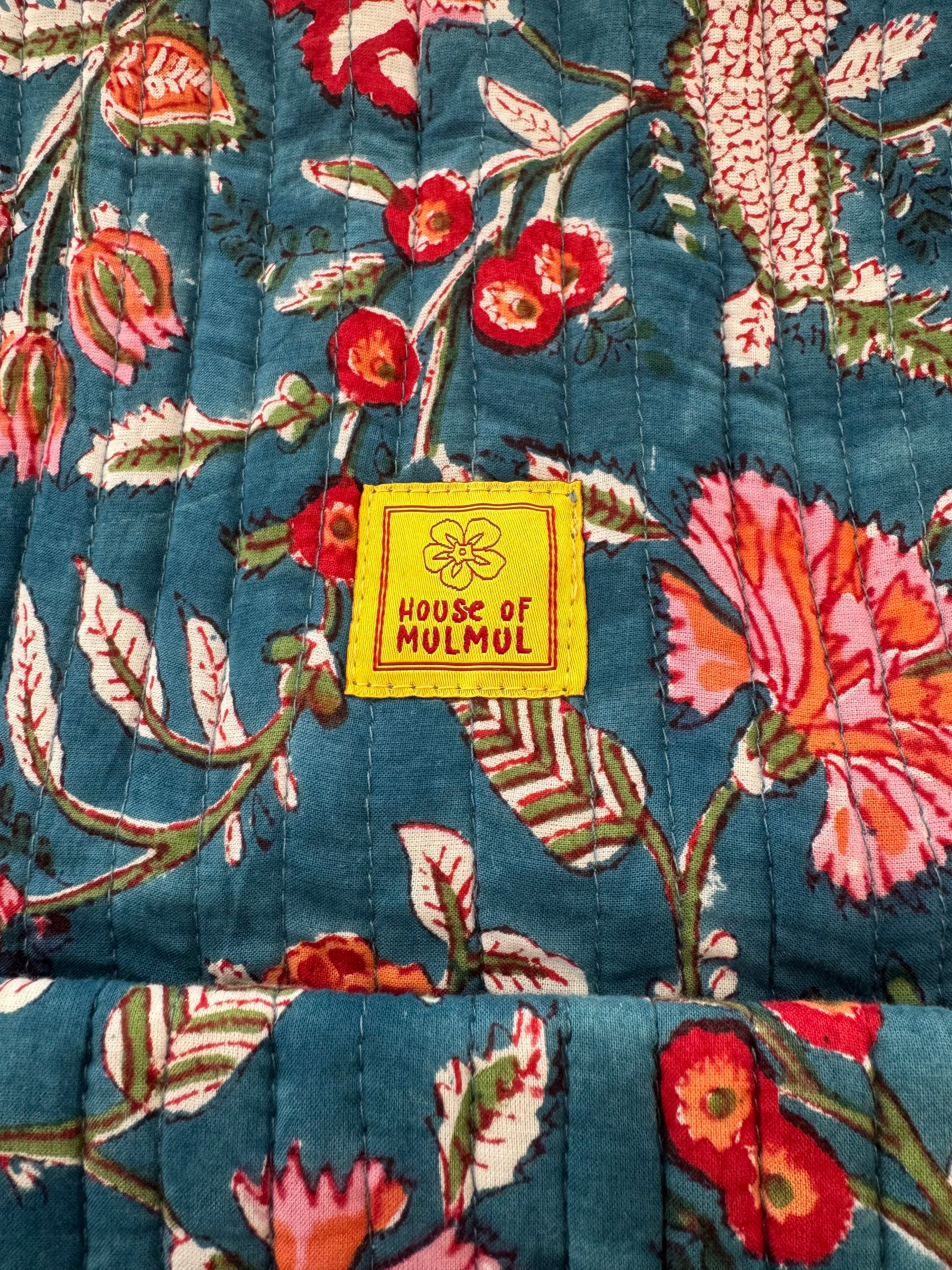 Floral patterned handblock printed fabric with a 'House of Mulmul' label.