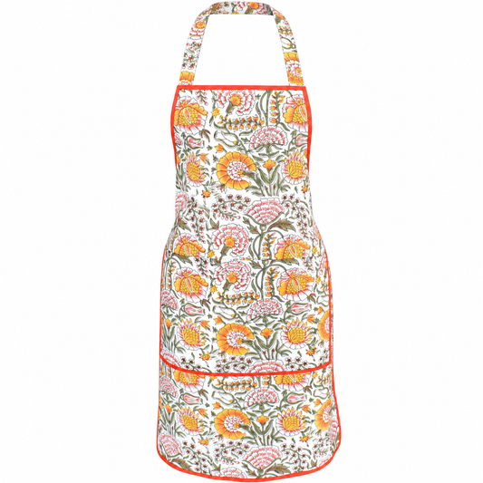 House of Mulmul - Blockprint Cotton Apron. A white apron with a vibrant orange, pink, and green floral block-print pattern, featuring a neck strap and two front pockets with orange piping.
