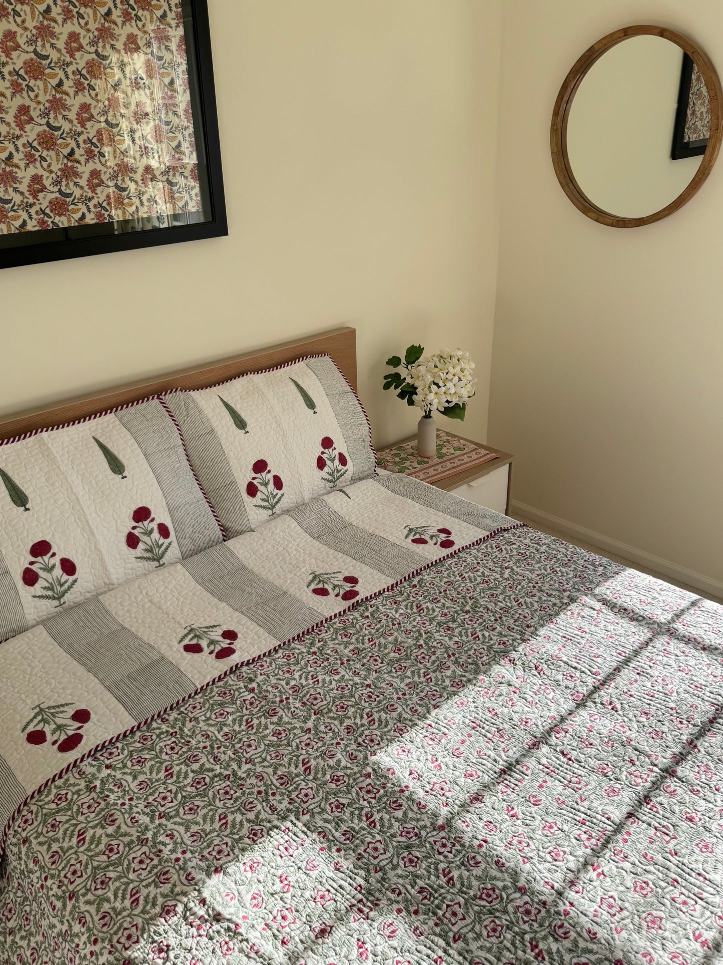 House of Mulmul - Blockprinted Cotton Bedcover Reversible Muslin. Bedroom with floral cotton bedspread, headboard, and mirror on the wall.