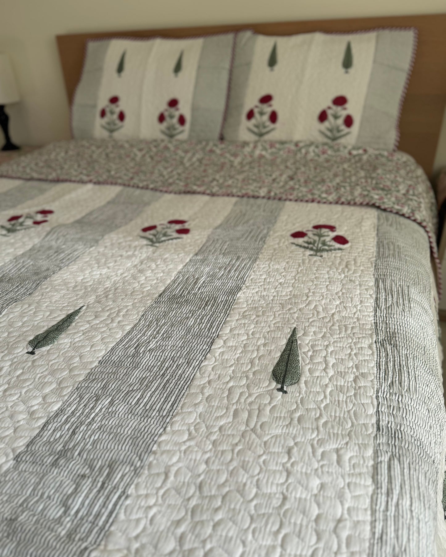 House of Mulmul - Blockprinted Cotton Bedcover Reversible Muslin. Cotton bedcover with floral patterns on a bed
