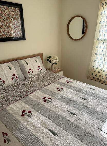 House of Mulmul - Blockprinted Cotton Bedcover Reversible Muslin. Bedroom with floral cotton bedspread, pillows, and decor elements.