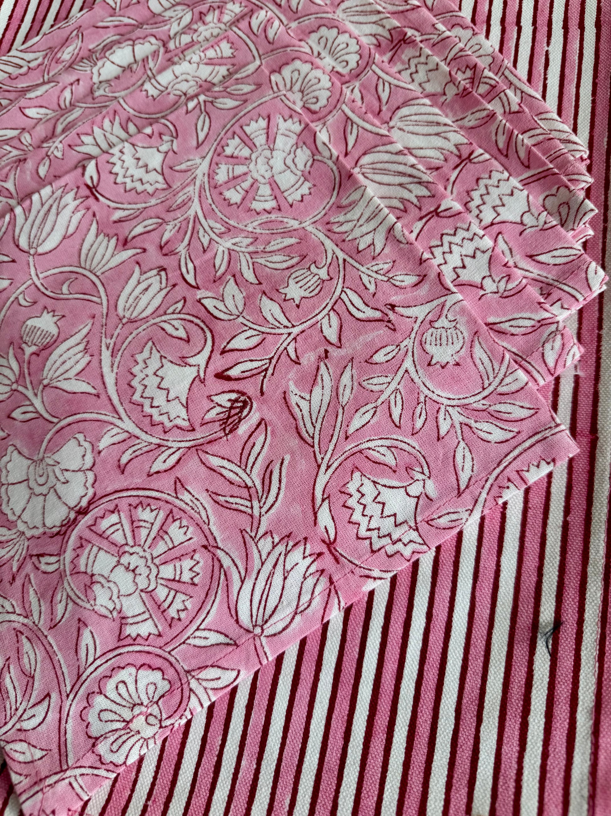 House of Mulmul - Blockprinted Cotton Mats and Napkins. Pink maps and napkins with white floral pattern on a striped background