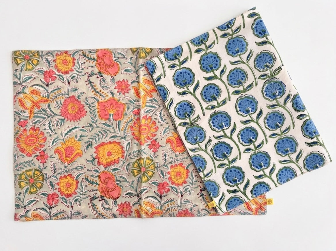 House of Mulmul - Blockprinted Cotton Reversible Table Runner & Mats set. Two reversible placemats with floral patterns on a white background