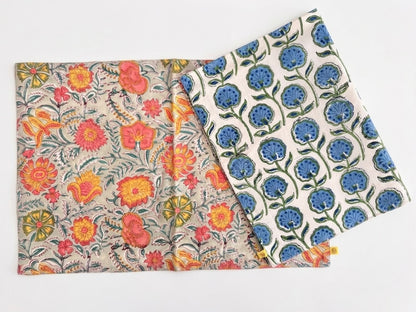 House of Mulmul - Blockprinted Cotton Reversible Table Runner & Mats set. Two reversible placemats with floral patterns on a white background
