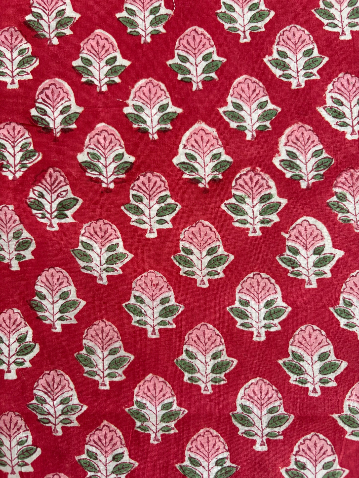House of Mulmul - Blockprinted Cotton Reversible Table Runner & Mats set. Patterned fabric with pink and green design on a red background
