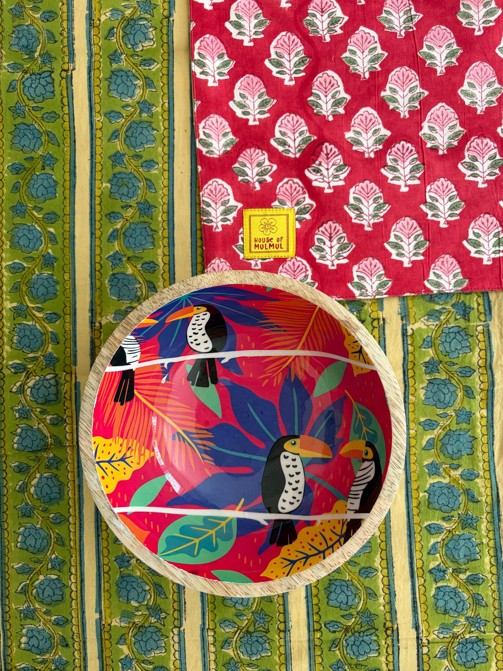 House of Mulmul - Blockprinted Cotton Reversible Table Runner & Mats set. Decorative plate with toucan design on a colorful fabric background