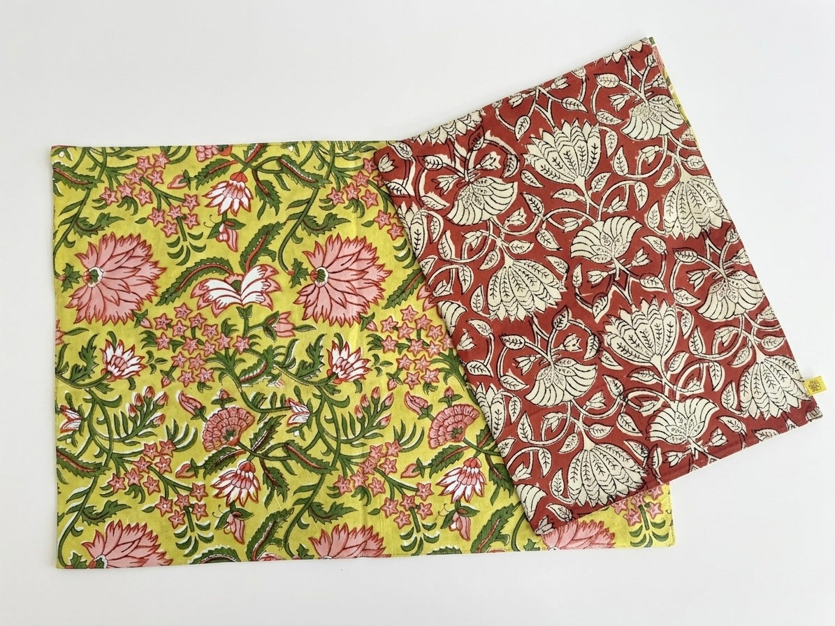 House of Mulmul - Blockprinted Cotton Reversible Table Runner & Mats set. Two floral-patterned placemats on a white background