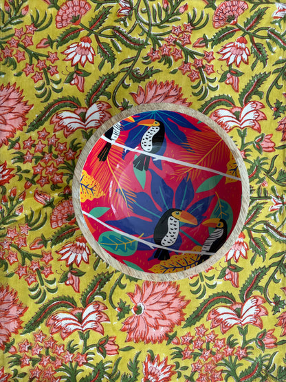 House of Mulmul - Blockprinted Cotton Reversible Table Runner & Mats set. Colorful woven basket with bird design on a floral patterned fabric background