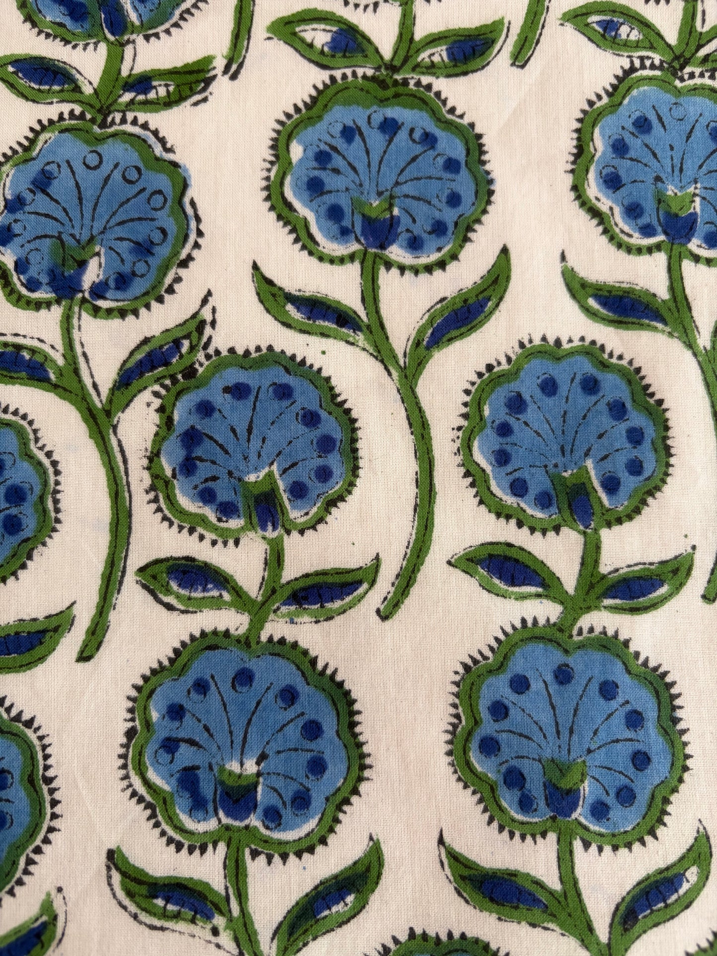House of Mulmul - Blockprinted Cotton Reversible Table Runner & Mats set. Pattern of blue flowers with green stems on a beige background