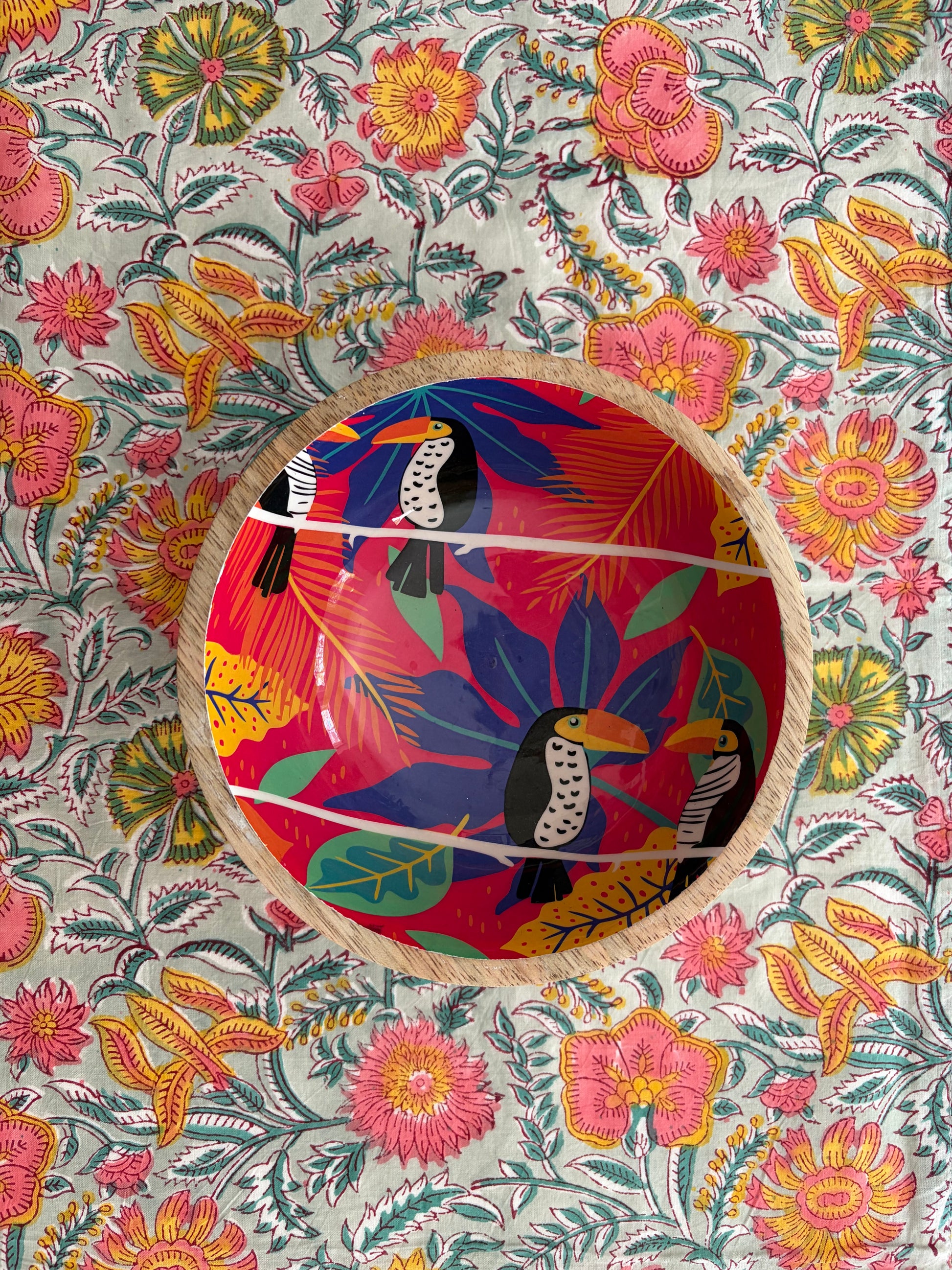 House of Mulmul - Blockprinted Cotton Reversible Table Runner & Mats set. Decorative plate with colorful bird design on a floral patterned background