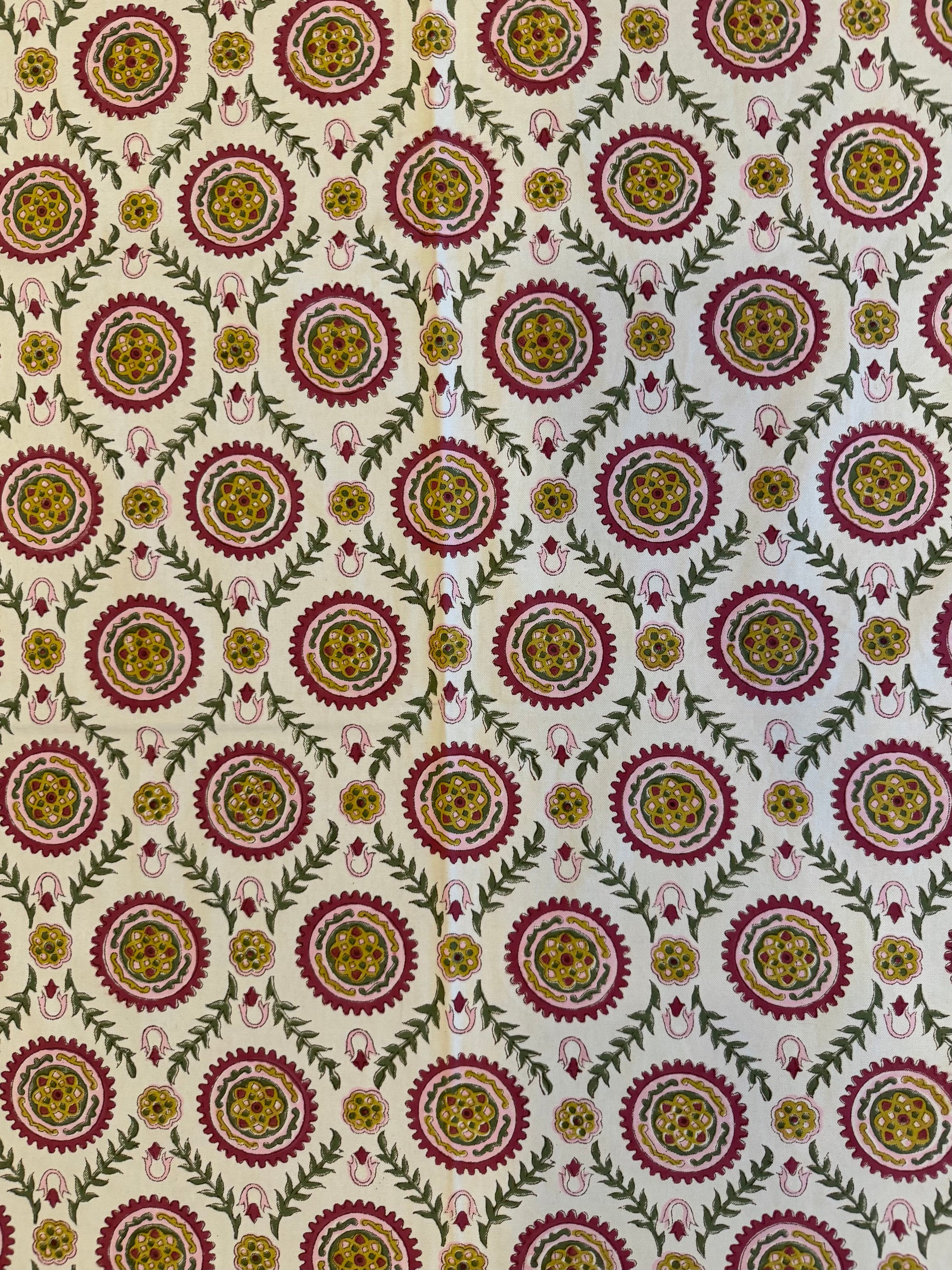 House of Mulmul - Blockprinted Cotton Table Cloth. Patterned table cover with circular designs in red, yellow, and green on a beige background