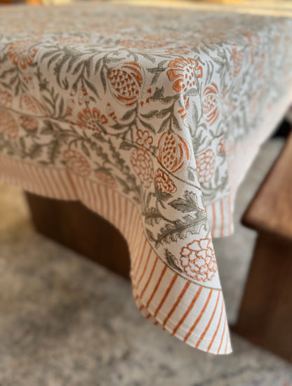 House of Mulmul - Blockprinted Cotton Table Cloth. Patterned tablecloth on a wooden table with a blurred background