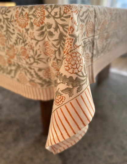 House of Mulmul - Blockprinted Cotton Table Cloth. Floral patterned tablecloth on a table with a blurred background