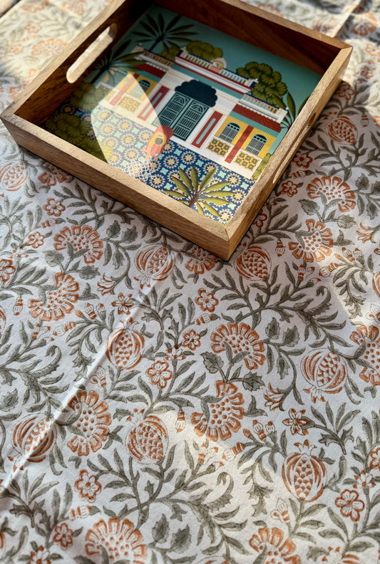 House of Mulmul - Blockprinted Cotton Table Cloth. Decorative tray with a colorful building illustration on a patterned tablecloth