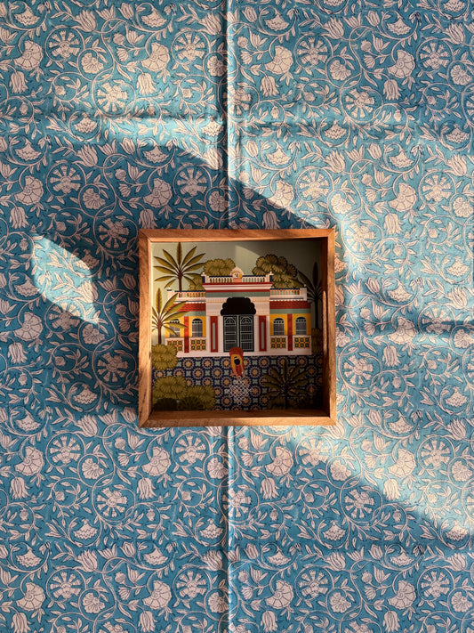 House of Mulmul - Blockprinted Cotton Table Cloth. Miniature architectural model in a wooden box on a floral-patterned fabric background