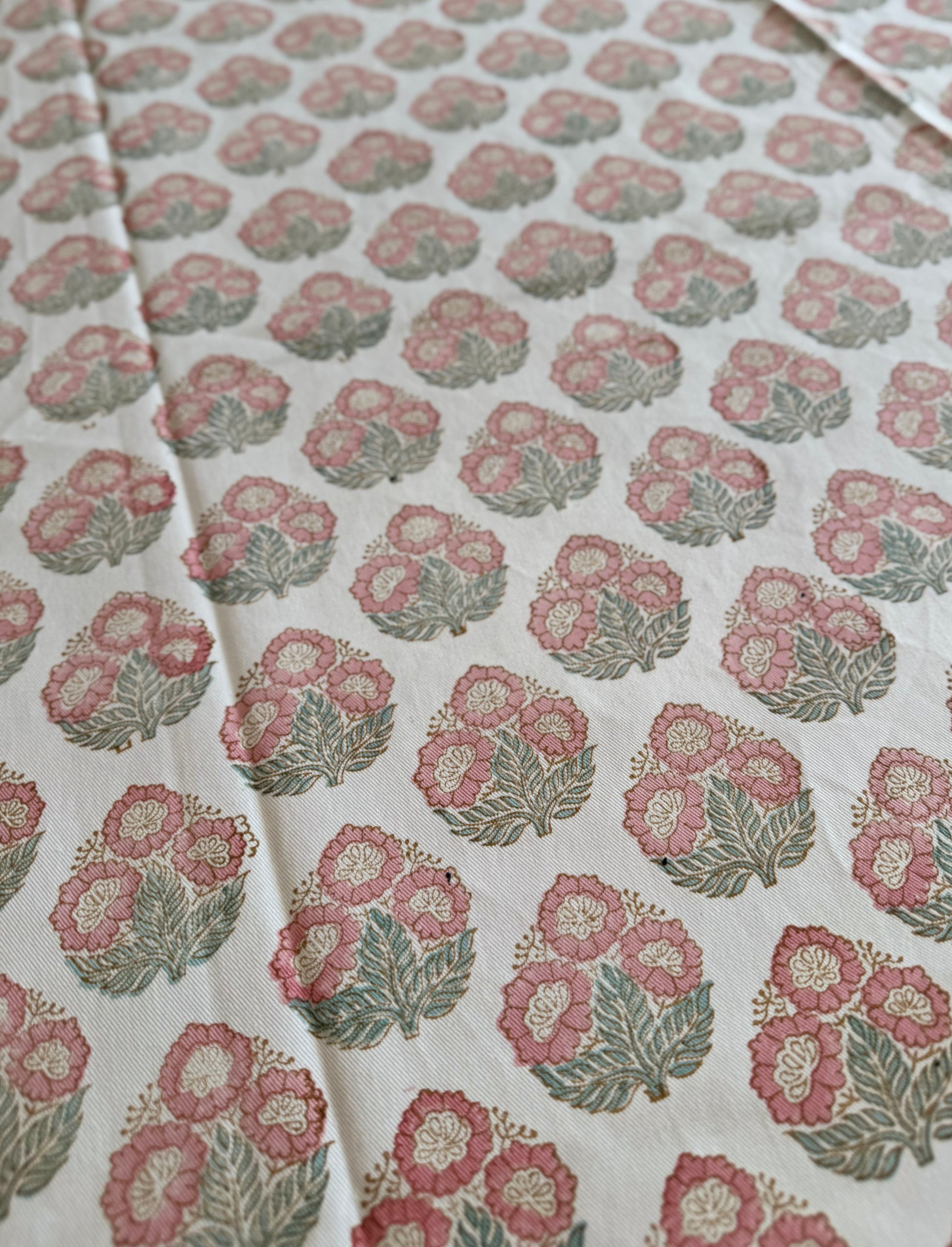 House of Mulmul - Blockprinted Cotton Table Cloth. Floral patterned cotton table cover with pink and green flowers on a white background