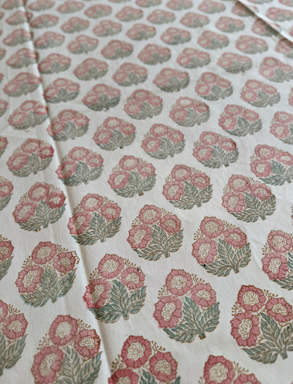 House of Mulmul - Blockprinted Cotton Table Cloth. Floral patterned cotton table cover with pink and green flowers on a white background