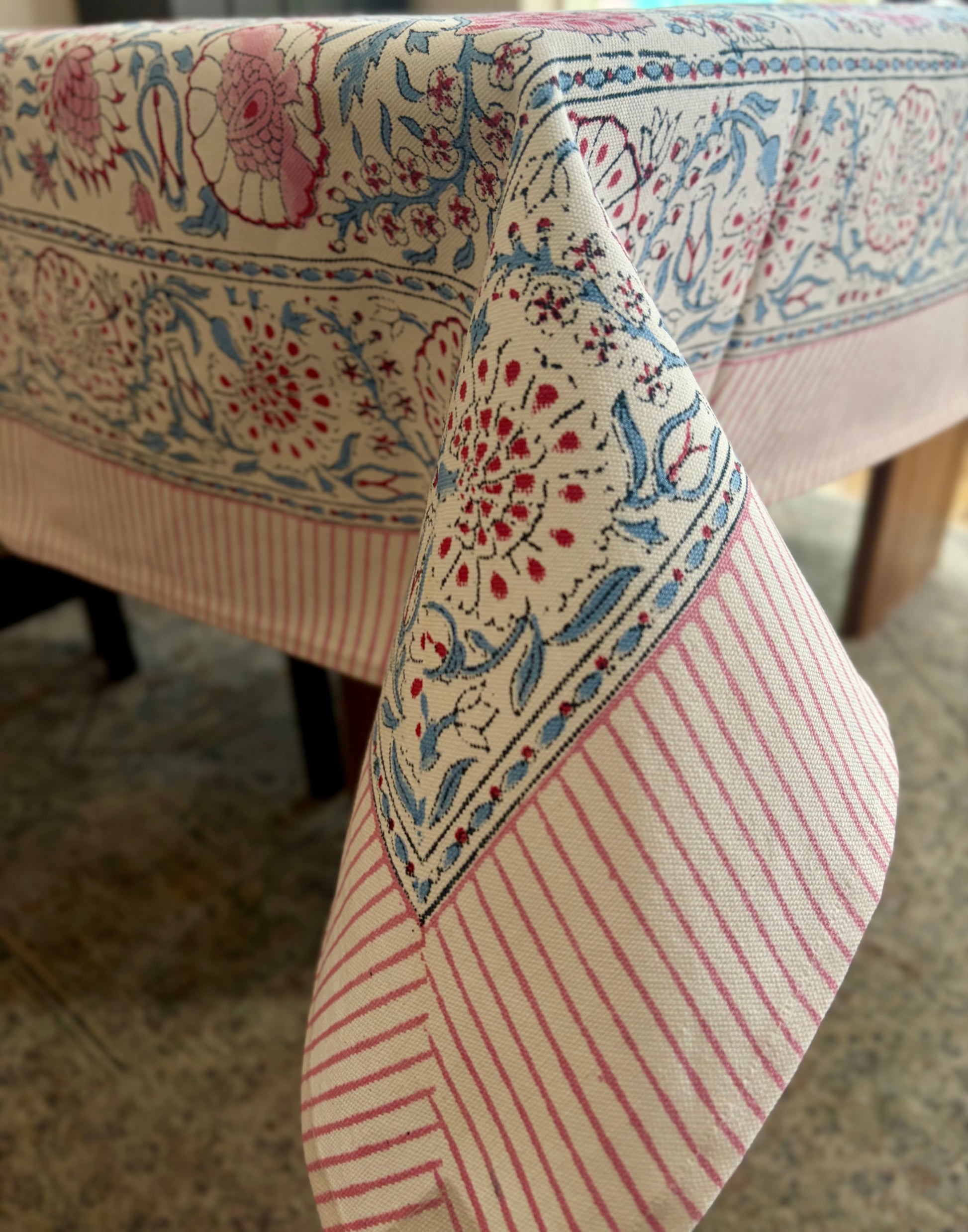 House of Mulmul - Blockprinted Cotton Table Cloth. Close-up of a patterned tablecloth with floral and striped designs.