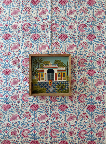 House of Mulmul - Blockprinted Cotton Table Cloth. Decorative wall with floral patterned wallpaper and framed artwork.