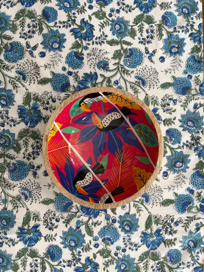House of Mulmul - Blockprinted Cotton Reversible Table Runner & Placemats set. Decorative plate with colorful bird design on a floral patterned background