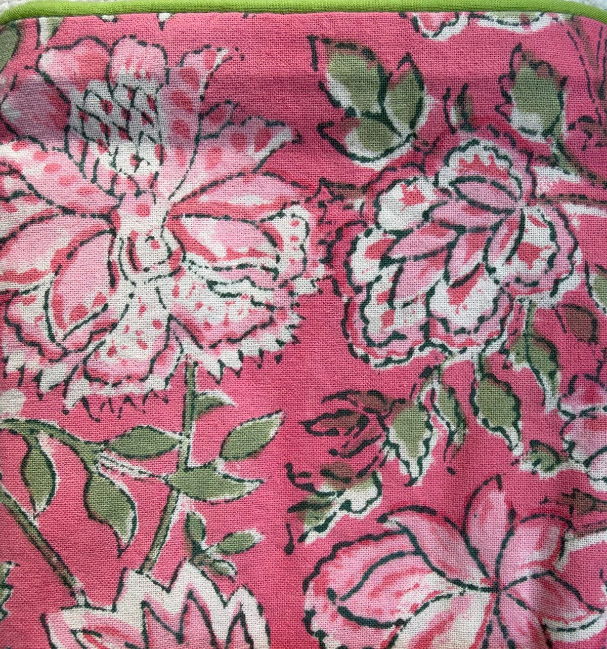 House of Mulmul - Blockprinted Cushion Covers-Pillow Cases. A close-up of a pink fabric with a bold floral block print pattern in pink, white, and green.