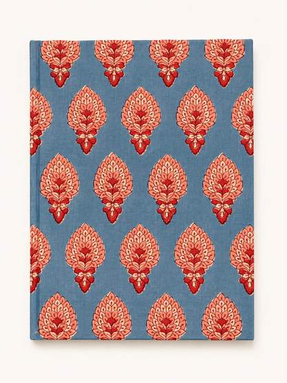 House of Mulmul - Blockprinted Journal Diary Notebook. A hardcover notebook with a blue cover featuring a repeating coral-red and pink floral block print pattern, shown against a plain off-white background.