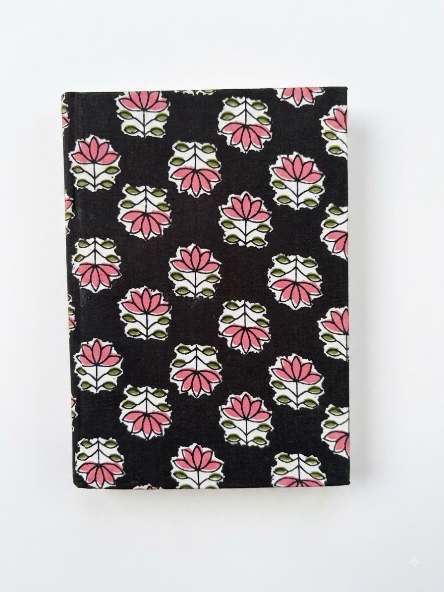 House of Mulmul - Blockprinted Journal Diary Notebook. A hardcover notebook with a black cover decorated with a repeating pink, white, and green block print floral pattern, shown against a plain white background.