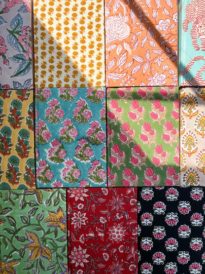 House of Mulmul - Blockprinted Journal Diary Notebook. A grid of colorful patterned notebooks arranged in a 3x4 layout, featuring various floral and geometric block prints in pink, yellow, green, red, and black.