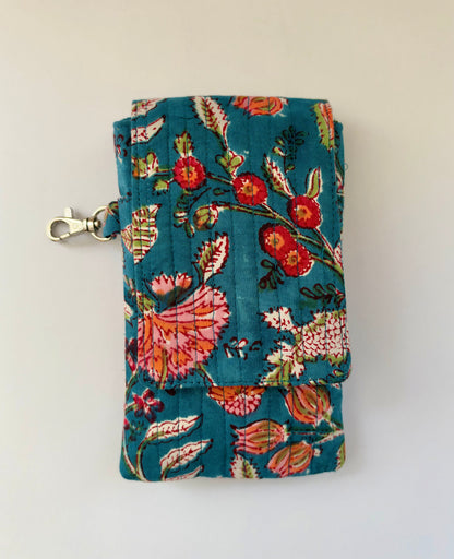 House of Mulmul - Blockprinted Mobile Sling Bag. A teal fabric pouch with a colorful floral and butterfly print, featuring a silver lobster clasp on the side, photographed against a plain off-white background.