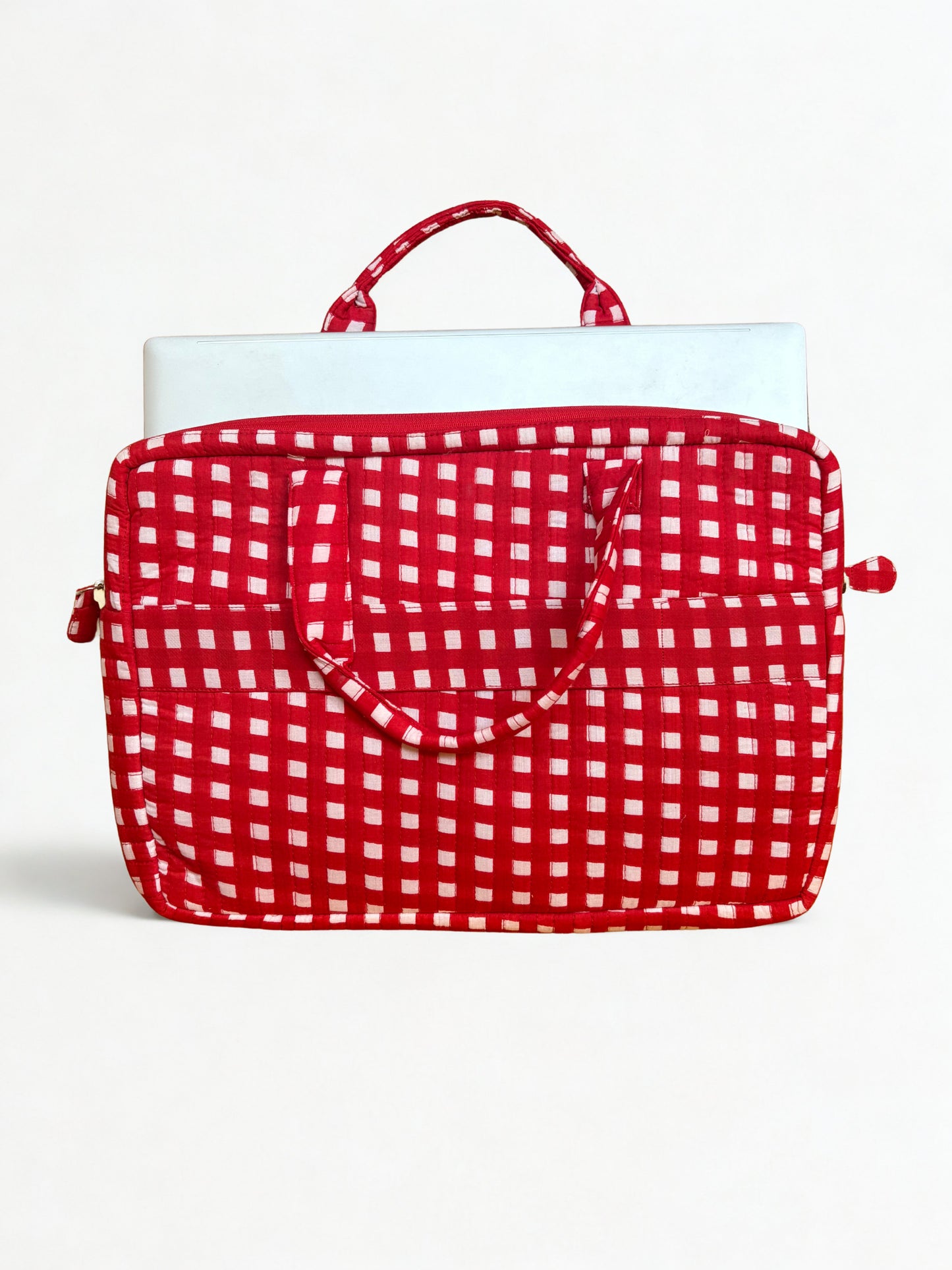 House of Mulmul - Blockprinted Cotton Quilted Laptop Bag. A red and white gingham patterned laptop sleeve with a top handle, shown holding a silver laptop against a plain white background.