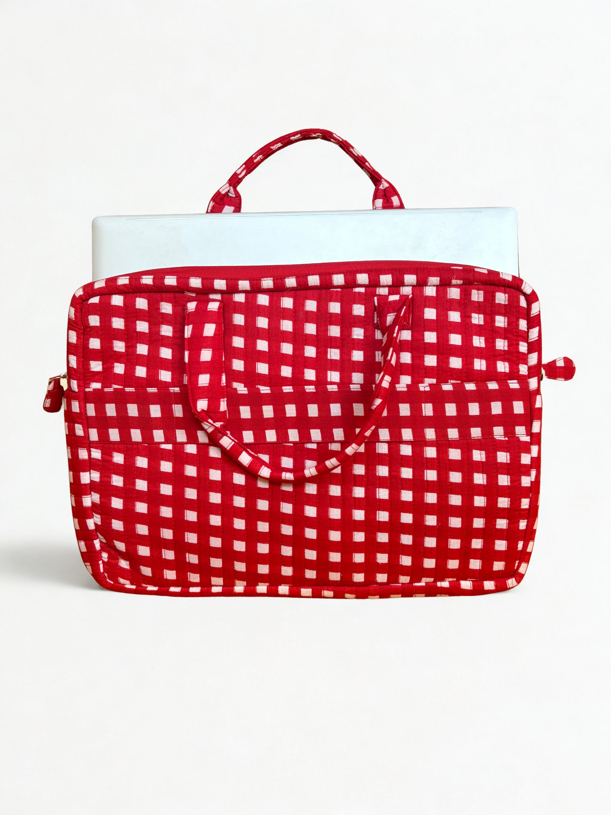 House of Mulmul - Blockprinted Cotton Quilted Laptop Bag. A red and white gingham patterned laptop sleeve with a top handle, shown holding a silver laptop against a plain white background.