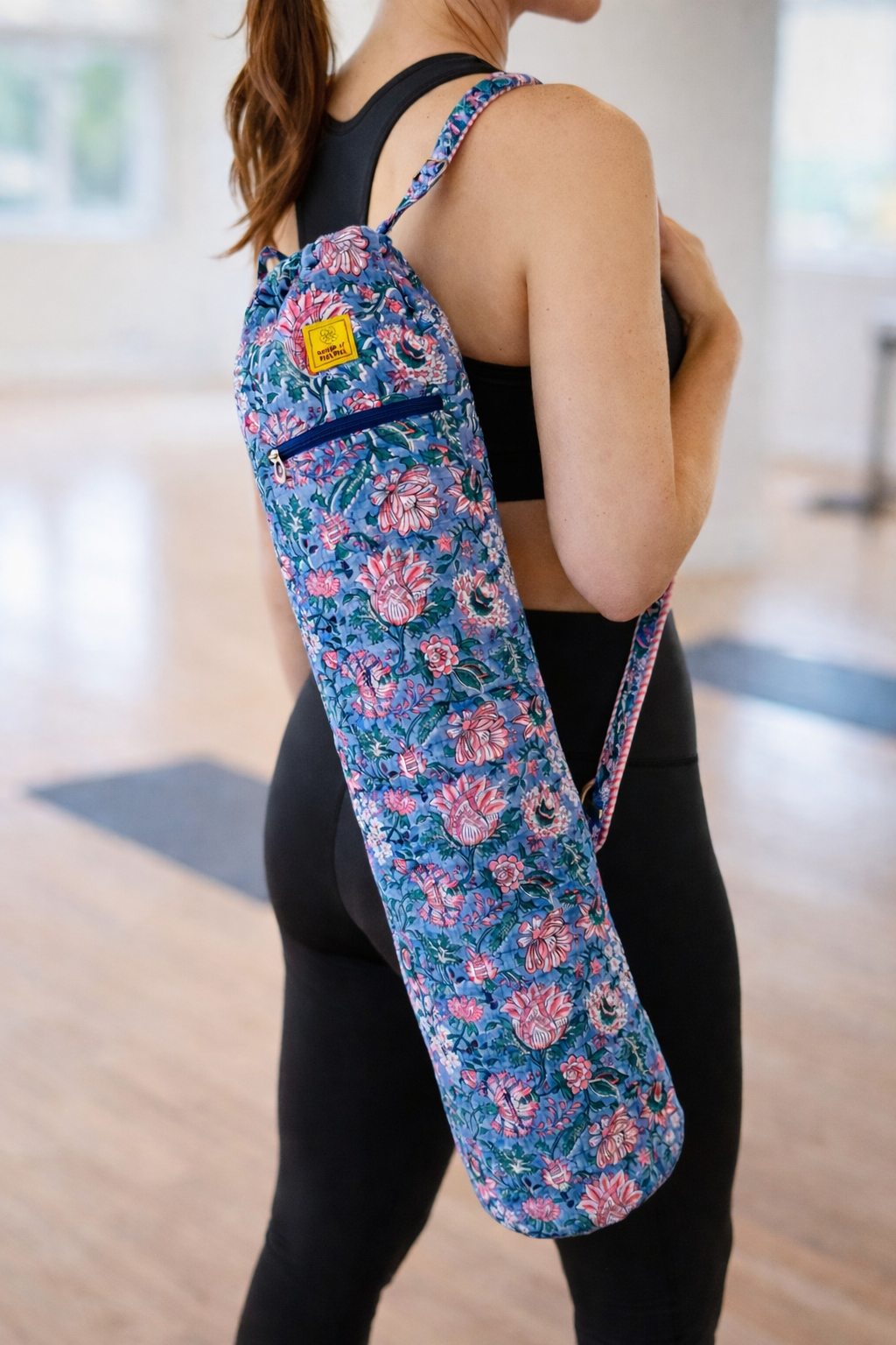 House of Mulmul - Blockprinted Yoga Mat Cover. Person holding a floral yoga mat bag.