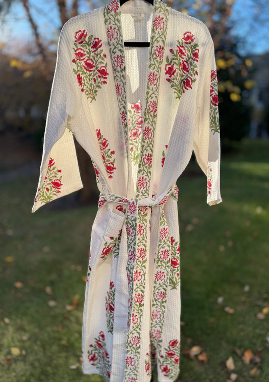 House of Mulmul - Cotton Bath robe. Floral patterned robe hanging outdoors on a grassy background