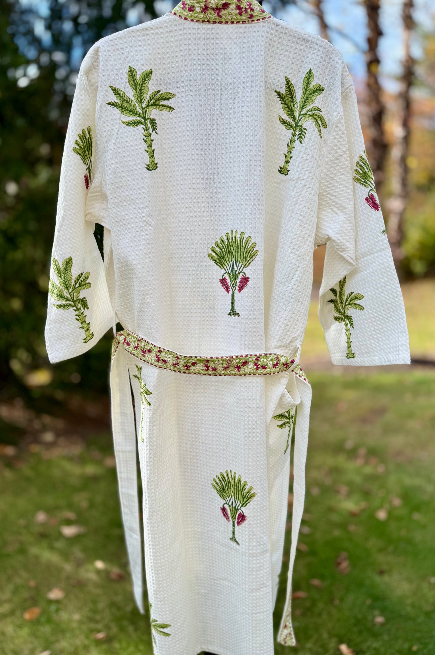 House of Mulmul - Cotton Bath robe. White embroidered robe with palm tree designs on a grassy background