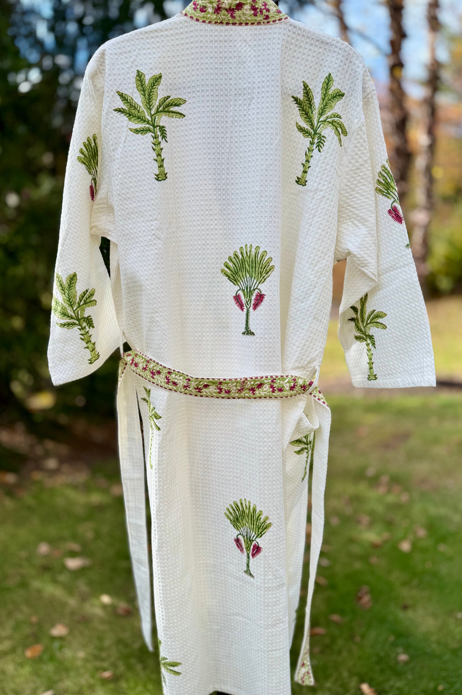 House of Mulmul - Cotton Bath robe. White embroidered robe with palm tree designs on a grassy background