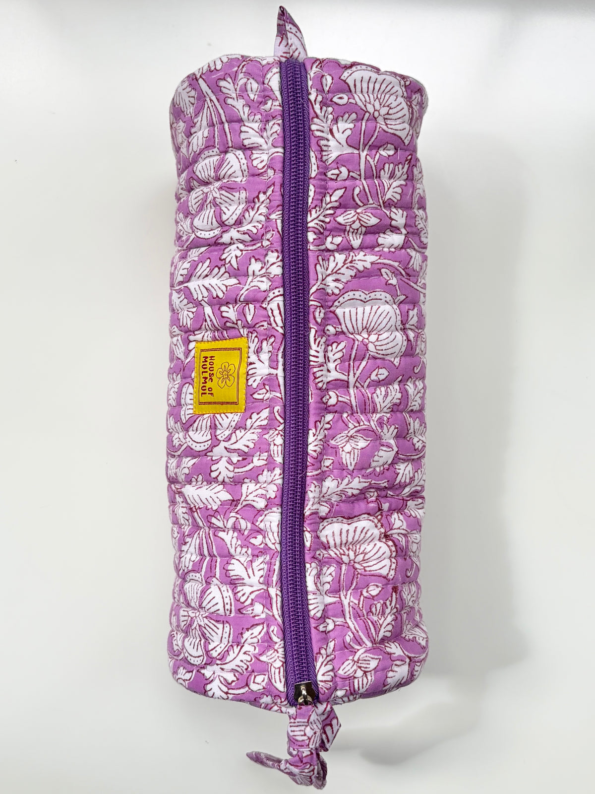 House of Mulmul - Cotton Quilted Makeup-Pencil Pouch. A purple and white floral patterned quilted travel pillow with a purple zipper and a small yellow brand label, shown against a plain white background.
