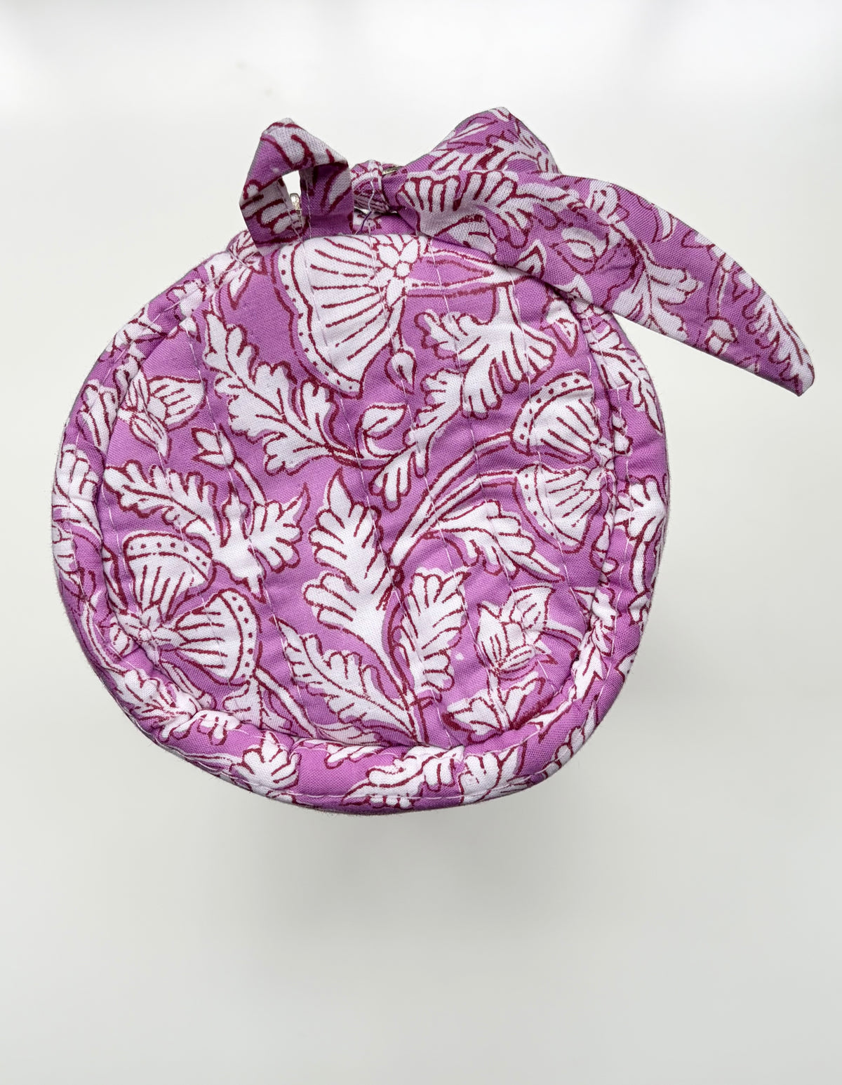 House of Mulmul - Cotton Quilted Makeup-Pencil Pouch. A round fabric headscarf or bonnet with a matching bow, featuring a white block-print style floral and leaf pattern on a purple background, shown against a plain white backdrop.