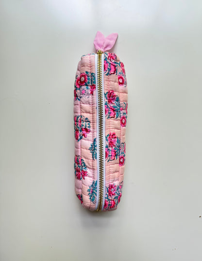 House of Mulmul - Cotton Quilted Makeup Barrel Pouch. A pink quilted zipper pouch with a floral print and a small pink bow at the top, shown against a plain light background.
