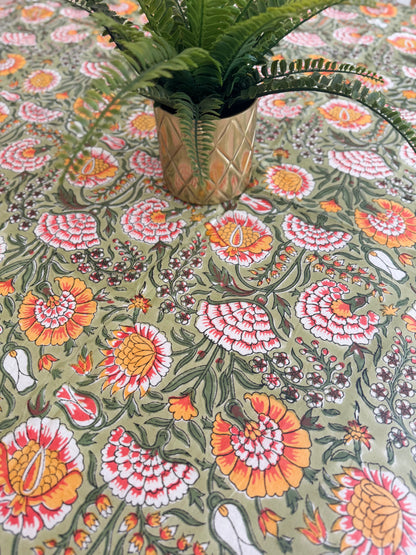 House of Mulmul - Cotton Table Cloth Round. Floral patterned fabric with a plant on top