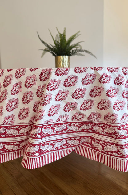 House of Mulmul - Cotton Table Cloth Round. Tablecloth with red floral pattern on a wooden table