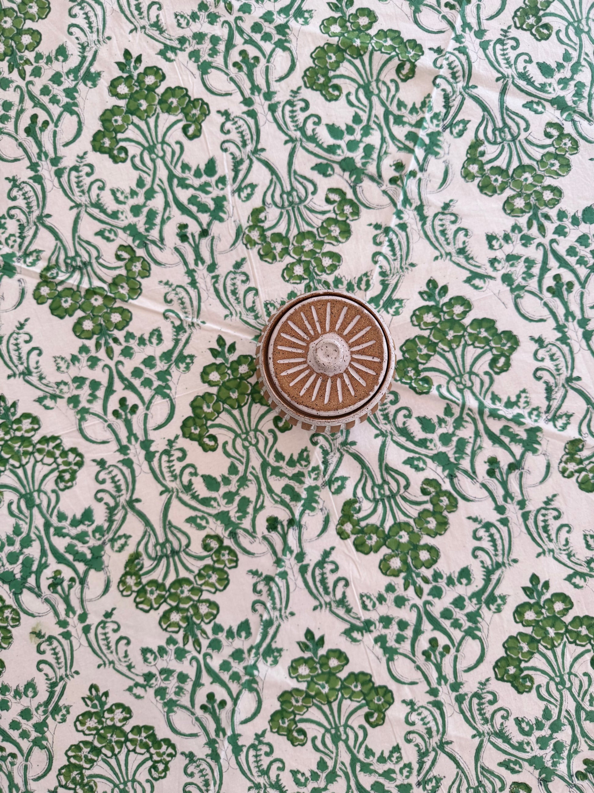 House of Mulmul - Cotton Table Cloth Round. Decorative green floral pattern on a white background with a central circular design.
