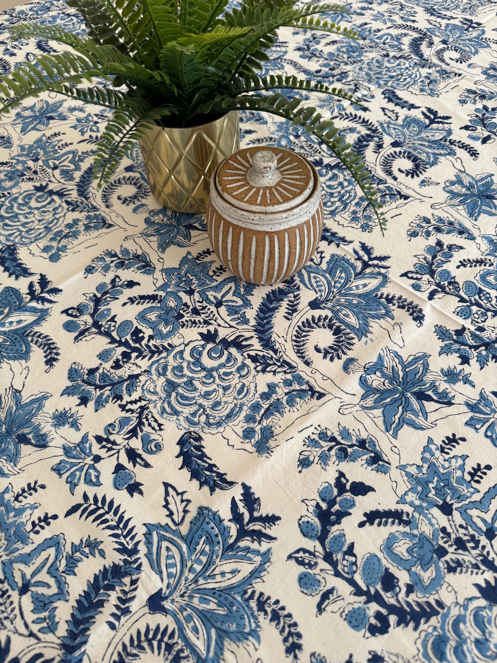 House of Mulmul - Cotton Table Cloth Round. Decorative vase on a floral patterned fabric background