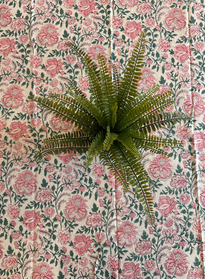 House of Mulmul - Cotton Table Cloth Round. Floral patterned tablecloth on a table with a plant.
