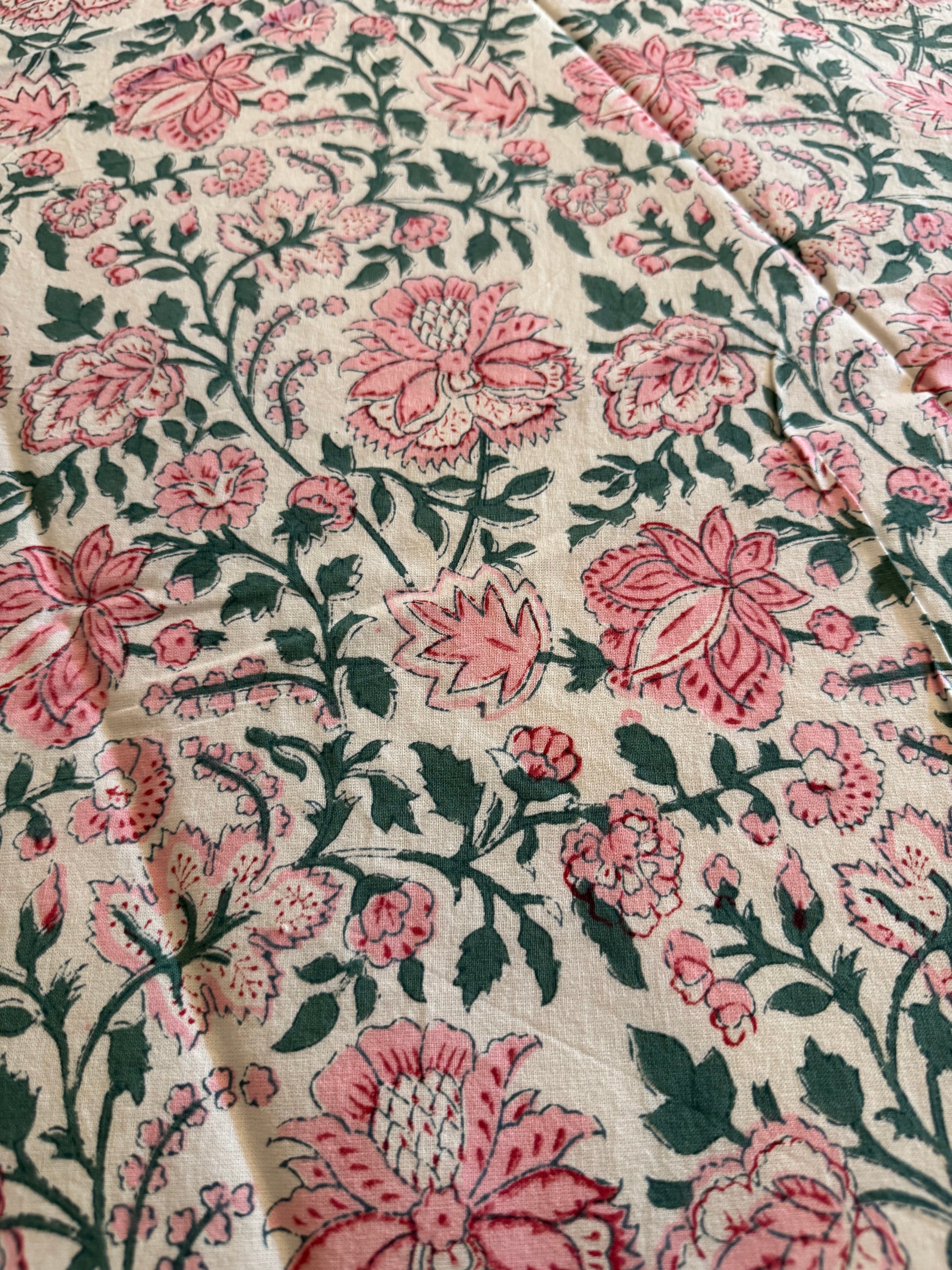House of Mulmul - Cotton Table Cloth Round. Close-up of floral fabric with pink and green pattern